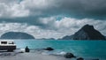 Monochrome Scene with Man, Blue Sea, Mountains, and Black Van. Generative AI Royalty Free Stock Photo