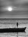 Monochrome shot of Boy on boat at sunset, Stone Town Zanzibar Royalty Free Stock Photo