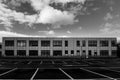 Monochrome shot of flat square building and car park