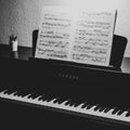 Monochrome shot of the Yamaha piano with music sheet