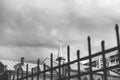 Monochrome spire of Catholic church with cross and wrought fence Royalty Free Stock Photo