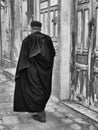 Monochrome, tall, Tunisian senior walking alone through Sousse street