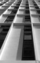 Monochrome vertical view of a tall concrete angular modern high building with geometric white details Royalty Free Stock Photo