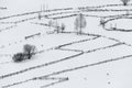 Monochrome Winter Rural Landscape With A Broken Line Of Wooden Fences, Haystacks, Trees And Flying Crows. Carpathian Mountains, Th Royalty Free Stock Photo