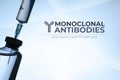 Monoclonal antibodies concept image: vial and syringe silhouette on light blue background