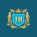 Monogram JH letters - concept logo template design. Crest heraldic luxury emblem. Blue shield, golden leaves and crown. Initials Royalty Free Stock Photo