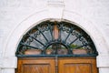 Monogrammed metal wrought iron lattice over wooden door Royalty Free Stock Photo