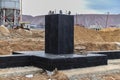 Monolithic reinforced concrete foundation waterproofed with bituminous mastic. Rostverk at the construction site. Construction pit Royalty Free Stock Photo