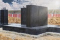 Monolithic reinforced concrete foundation waterproofed with bituminous mastic. Rostverk at the construction site. Construction pit Royalty Free Stock Photo