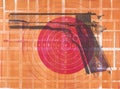 Monoprint of a Colt 1911 pistol and a paper target