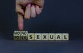 Monosexual or polysexual symbol. Doctor turns wooden cubes and changes the word `monosexual` to `polysexual`. Beautiful grey Royalty Free Stock Photo