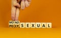 Monosexual or polysexual symbol. Doctor turns wooden cubes and changes the word `monosexual` to `polysexual`. Beautiful orange Royalty Free Stock Photo