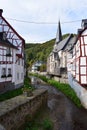 Monreal, Germany - 10 01 2021: Elz between half timbered houses and the stone church Royalty Free Stock Photo