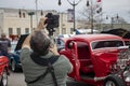 A photographer captures the street scene at a car show in Monroe Georgia.