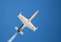 An L-39 Albatros jet flying against a deep blue sky