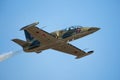 An L-39 Albatros jet flying against a deep blue sky