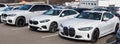 Monroeville, Pennsylvania, USA February 12, 2023 Three white BMWs lined up for sale at a dealership