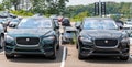 Monroeville, Pennsylvania, USA July 18, 2021 A green and a black Jaguar SUVs parked together in a parking lot at a dealership