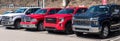 Monroeville, Pennsylvania, USA March 26, 2023 Four different pickup trucks, a Ford, Chevy, Ram and a GMC for sale at a dealership Royalty Free Stock Photo