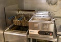 A deep fryer machine in the kitchen of a pizza shop Royalty Free Stock Photo