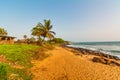 Monrovia, Liberia - April 23, 2019: Beach with red sand and black rocks with a blue sky in Congo Town, Monrovia, Liberia