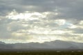 Monsoon rain clouds over mountain range edge of dry Mojave Desert valley Nevada, USA Royalty Free Stock Photo