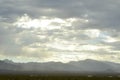 Monsoon rain clouds over mountain range edge of dry Mojave Desert valley Nevada, USA Royalty Free Stock Photo