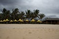 Monsoon storm tempest on the beach with palms and umbrellas. Royalty Free Stock Photo