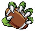 Monster animal claw holding American Football Ball