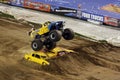 Monster truck jumps over cars