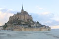 Mont Saint-Michel at low tide pink blue sunset twilight clouds sand horizon Royalty Free Stock Photo