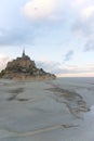 Mont Saint Michel at low tide vertical picture portrait sunset pink twilight clouds horizon historical unesco heritage sites of Royalty Free Stock Photo