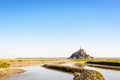 The Mont Saint-Michel tidal island in Normandy, France, and the Couesnon river by a sunny morning Royalty Free Stock Photo