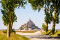 The Mont Saint-Michel tidal island in Normandy, France, seen between poplar trees Royalty Free Stock Photo