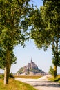 The Mont Saint-Michel tidal island in Normandy, France, seen between poplar trees Royalty Free Stock Photo