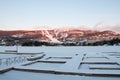 Winter landscape of Ski Resort with Frozen Lake, Ski Slopes, Docks and Blue Sky - Mont-Tremblant, Quebec, Canada Royalty Free Stock Photo