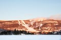 Winter landscape of Ski Resort with Frozen Lake, Ski Slopes and Blue Sky - Mont-Tremblant, Quebec, Canada Royalty Free Stock Photo