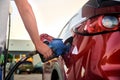 MONT-TREMBLANT, QUEBEC, CANADA, - SEPTEMBER 13, 2018: Male hand refuel a red car with gasoline at a gas station, close Royalty Free Stock Photo