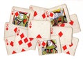A montage of torn halves of vintage playing cards featuring diamonds.