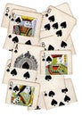 A montage of torn halves of vintage playing cards featuring spades.