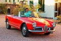 Montagnana, Italy August 27, 2018: Girl driving Retro car Alfa Romeo convertible 1961 ode release.