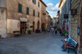 Montalcino, Tuscany, Italy. August 2020. The typical local wine shops overlook the main street of the village, people walk through Royalty Free Stock Photo