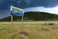 A Wyoming State welcome sign with mountains on the background in Western USA