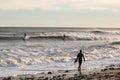 Montauk, New York - January 1, 2019 : Winter surfers in wetsuits enjoying nice waves off the coast of Long Island New York