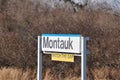 Montauk railroad station sign with posted Watch The Gap warning in yellow Royalty Free Stock Photo