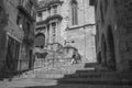 Black and white street picture with steps to the church with people in the historic quarter village Montblanc.