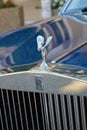 Rolls Royce luxury blue car, silver logo and statue detail in a summer day in Monte Carlo