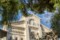 Monte Carlo, Monaco, 05/05/2019: A beautiful white palace framed by tree branches. Close-up Royalty Free Stock Photo