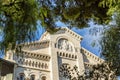 Monte Carlo, Monaco, 05/05/2019: A beautiful white palace framed by tree branches. Close-up