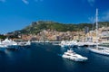 Monte Carlo, Monaco - December 08, 2009: sea harbor with yachts and city on mountain landscape. Houses on sea shore with